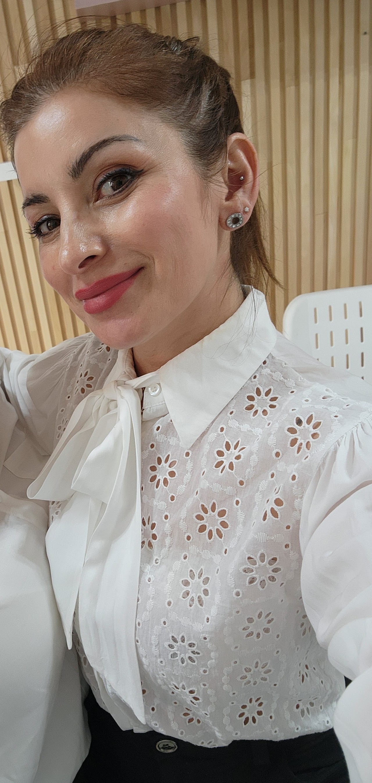 Laser hair removal treatment session in a pristine luxury clinic, professional aesthetician using a modern laser applicator on leg or arm, protective goggles, clinical precision, soft ambient warm spa light